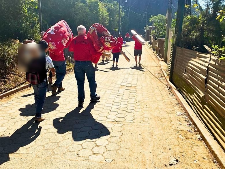 Carrying beds up the village road