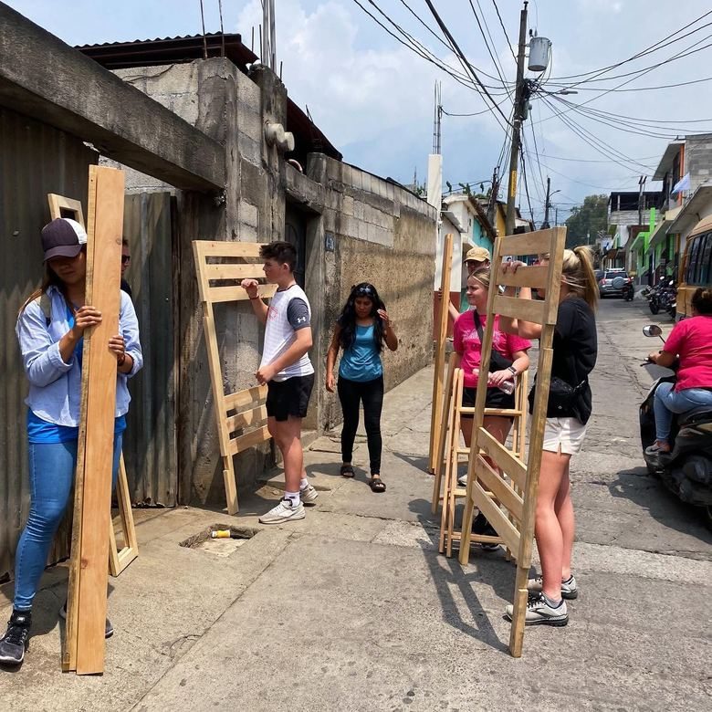 Carrying lumber for beds up the street