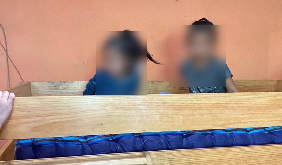 Two children at their new bunk bed
